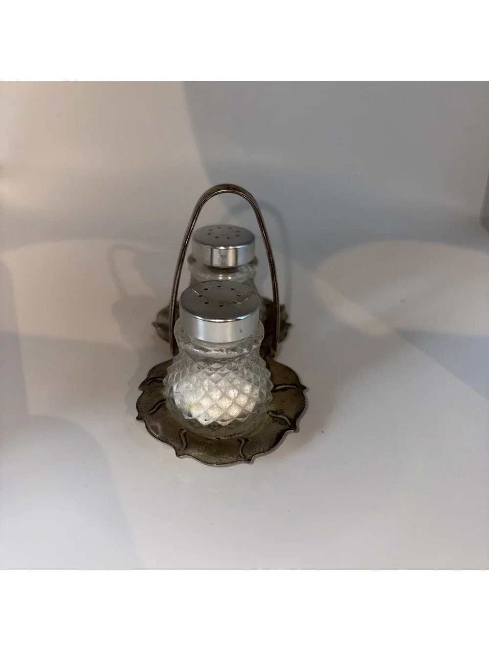 Miniature glass salt and pepper shakers with chrome lids and base holder